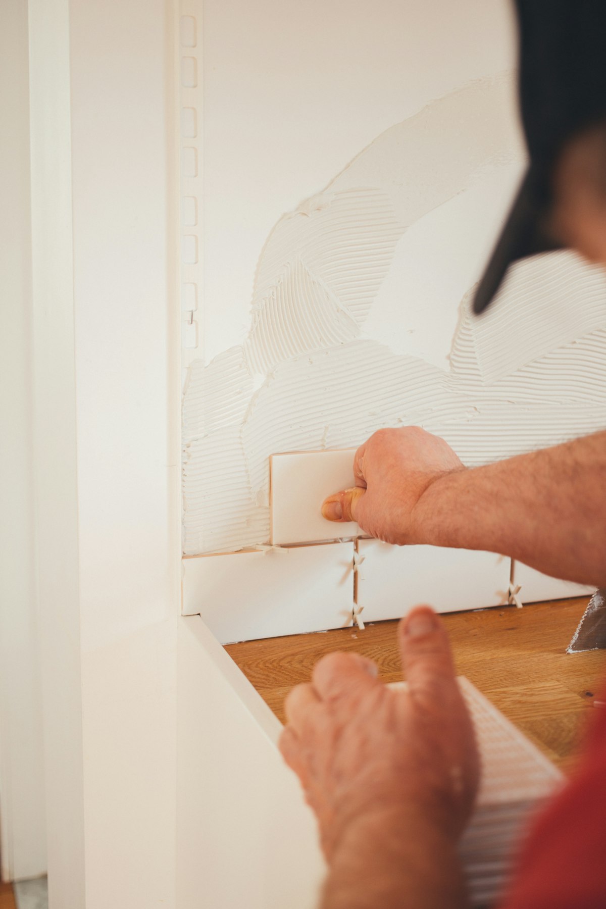 Hands laying tile